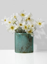 white cosmos arrangement in patina glass vase